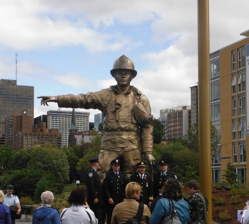 "Firefighters posing with the Statue"